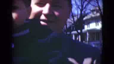 Middletown Pennsylvania (1975): A Man In A Grey Jacket Holding A Toddler In A Blue