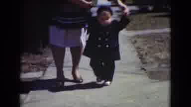 Middletown Pennsylvania (1975): A Woman Walking A Young Toddler Boy Gently Down