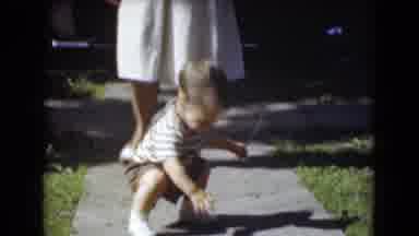 Middletown Pennsylvania (1975): A Small Child With Brown Hair Walking Down A