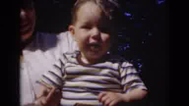 Middletown Pennsylvania (1975): Young Boy Proudly Gripping A Small Stick Being