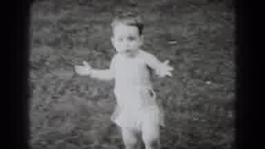 Middletown Pennsylvania (1975): Baby Wearing White Shorts Walks Through Grass