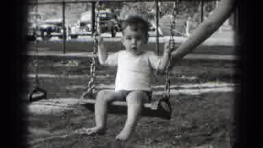 Middletown Pennsylvania (1975): Young Boy Without Shoes On Carefully Being Pushed