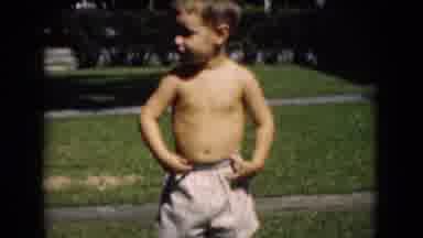 Middletown Pennsylvania (1975): Boy Wearing White Shorts Walks Toward Camera On
