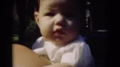 Middletown Pennsylvania (1975): Baby Being Held By A Woman And Looking Over At The