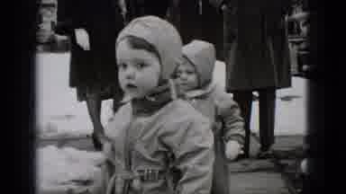 Middletown Pennsylvania-1975: Two Young Children Bundled In Snowsuits Walking On Sidewalk