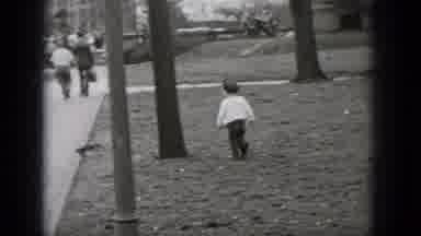 Middletown Pennsylvania (1975): Child Runs After Squirrel Across Grassy Area As