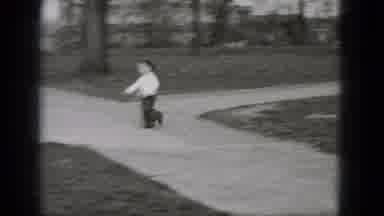Middletown Pennsylvania (1975): Young Boy Running Down A Sidewalk To Chase Off A