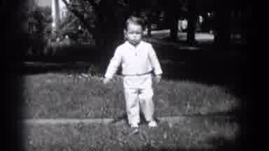 Middletown Pennsylvania-1975: Young Boy Dressed Up Running Towards Camera at Family Gathering