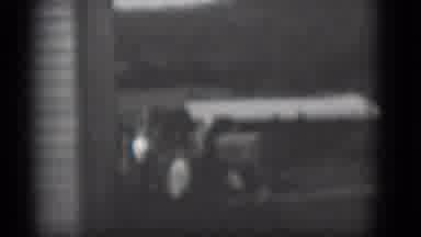 Middletown Pennsylvania (1975): Tractor Parked Beside White Building On A Bright