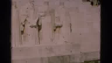 PORTUGAL-1975: Man Walks Past White Stone Bas-Relief Artwork On A Bright