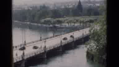 PORTUGAL-1975: Cars Traveling On Bridge Surrounded By Water On Both Sides