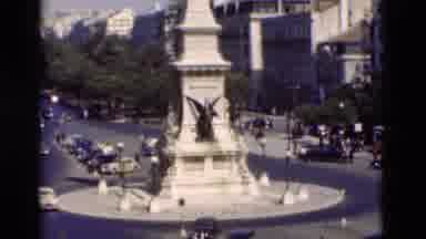 Portugal (1975): Automobiles And People Traveling Near Monument In Busy City
