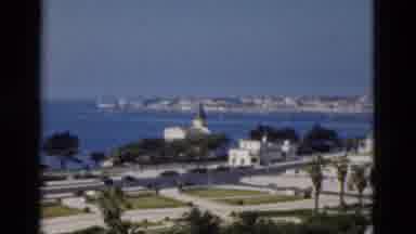 Portugal (1975): Camera Pans Across The Cityscape That Lies Behind The Water