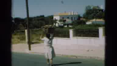 Portugal (1975): Women Walking With Baskets And People On A Busy Street In Daytime