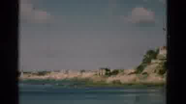 PORTUGAL-1975: Algae Covered Rocks With A White Building Along Ocean Cliffs