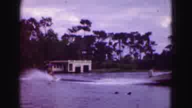 Florida Everglades USA (1975): Boat Speeding Past With A Water Skier Doing A Trick