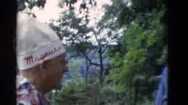 Somerset Kentucky USA (1975): Man In White Hat Stands Up In Front Of Several