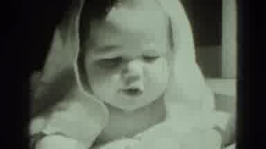 Middletown Pennsylvania (1975): A Baby Lounging On The Bed With Blanket Covering