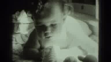 Middletown Pennsylvania (1975): Baby With A Little Curly Hair Fascinated By Toys