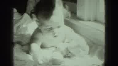 Middletown Pennsylvania (1975): Small Baby Girl Plays With Her Toys While Laying
