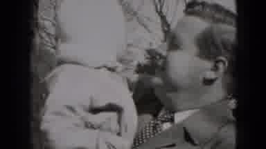 Middletown Pennsylvania (1975): Man With Child On Lap Observes Two Other Young