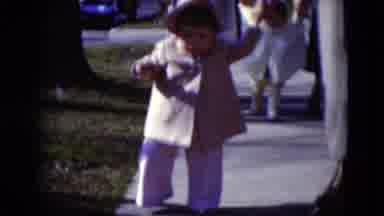 Middletown Pennsylvania (1975): Woman Helps Toddler Wearing Tan Coat And Hat To
