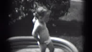 Middletown Pennsylvania (1975): A Playful Toddler In A Swim Tub Pulling Up Her