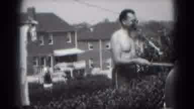 Middletown Pennsylvania (1975): Man Water Lawn With Hose While Children Sit In