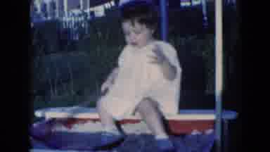 Middletown Pennsylvania (1975): Baby Girl In White Dress Plays In Sandbox With