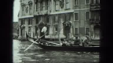 Venice Italy (1975): Man Steers A Boat Full Of Tourists Down The Canal Towards