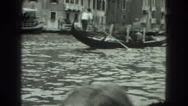 Venice Italy (1975): Gondolier Steers A Group Of People On A Gondola Through A