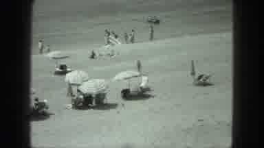 Venice Italy (1975): Many Beach Goers Lay Out Under Umbrellas As One Person