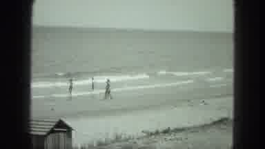 Venice Italy (1975): Three People Playing On A Beach With The Waves Of The Ocean