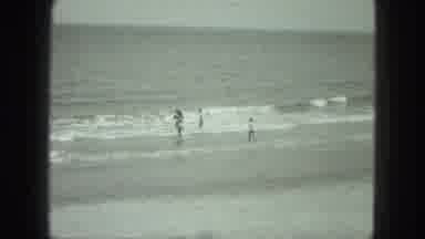 Venice Italy (1975): Four People Near The Sea And Are Moving Towards Waves