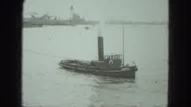 VENICE ITALY-1975: Steam Tugboat On Calm Waters With Industrial Port In Background