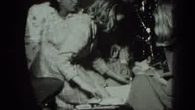 Milwaukee Wisconsin USA-1975: Black And White Scene Of 2 Young Girls Opening Christmas Gifts