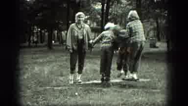 Milwaukee Wisconsin USA (1975): A Bunch Of Kids And An Adult Playing On A Log