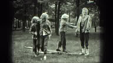 Milwaukee Wisconsin USA (1975): Girls Wearing Plaid Shirts Playing On A Piece Of