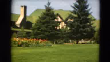 Minnesota Cabin Golf Course (1975): Lush Green Lawn With Red Blooming Flowers On A