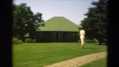 Duluth Minnesota USA (1975): Woman With A Dress Walking Around A Big Green Field