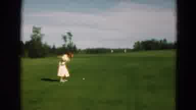 Duluth Minnesota USA (1975): Woman In A Dress Plays The Sport Of Golf On The Green