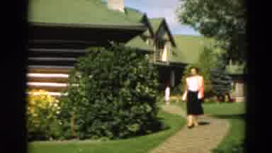 Duluth Minnesota USA (1975): Well Dressed Woman Walks Down The Walk Then Onto The