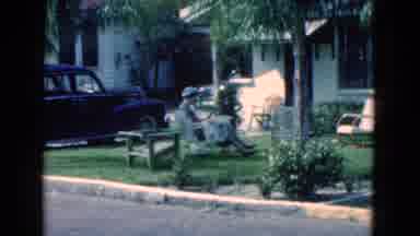 Florida USA (1975): A Lady Sits On A Bench In The Yard Next To A Driveway