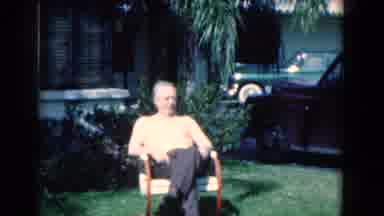 Florida USA (1975): An Old Man Sitting Outside On A Lawn In A Suburban