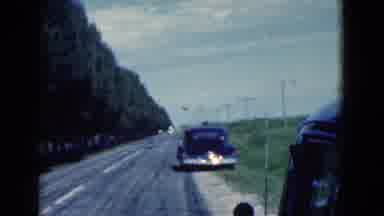 Florida USA (1975): View Down Two-Lane Road With Two Cars Parked Beside The Road;