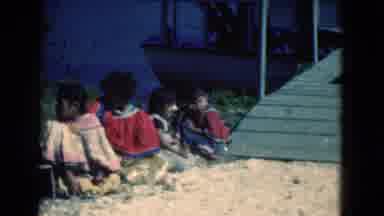 Florida USA (1975): People Sit On Ground Next To Green Ramp On A Bright Sunny Day