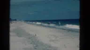 Florida USA (1975): Man Wearing Black Shorts Stands On Beach With Deep Blue Sea