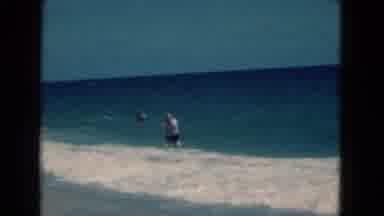 Florida USA (1975): A Man Fighting The Waves In The Water On The Beach