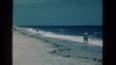 Florida USA (1975): People Wade Through Deep Blue Sea Water On A Bright Sunny Day