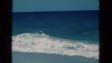 Florida USA (1975): Man Wading In Ocean Hit By Wave Walks To Beach